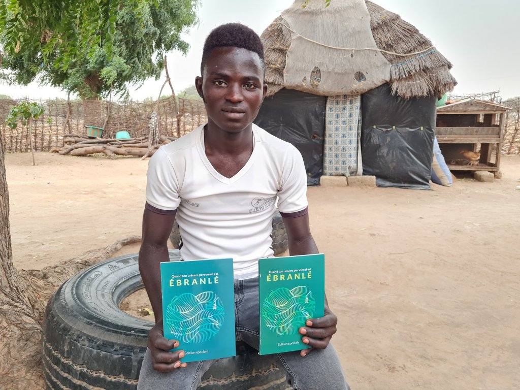 Boy holding When Your Whole World Changes books